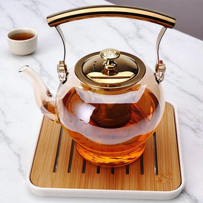 Glas und goldene Teekanne